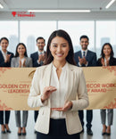 Woman in a beige blazer standing in front of a group clapping, with 'Shop Trophies' logo above.