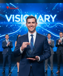 Man in a suit holding an award with 'VISIONARY' text and people clapping in the background.