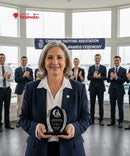 Woman holding an award in front of a group of people at a Canadian Yachting Association awards ceremony.