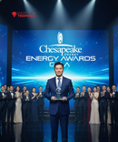 Man holding an award on a stage with 'Chesapeake Energy Awards' backdrop